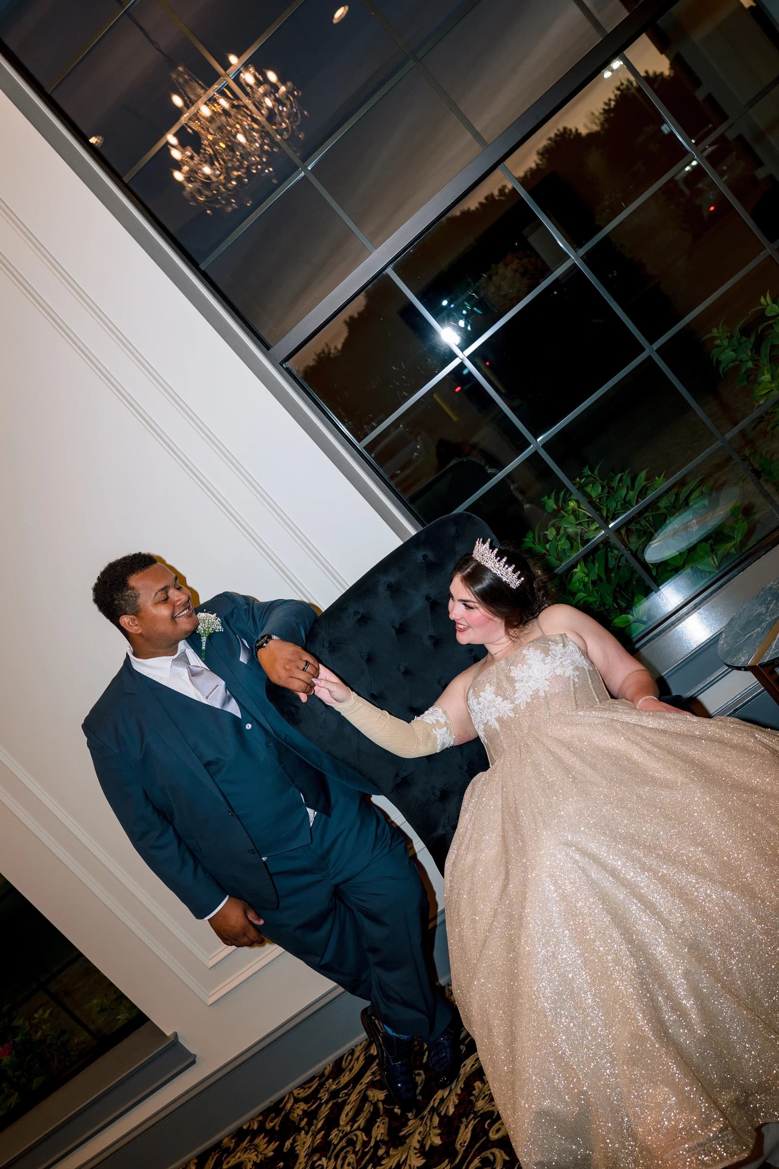 Bride wearing a gold custom PICC line cover with floral lace detailing while holding hands with her partner