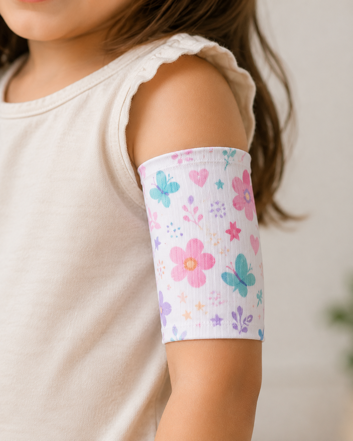 Child wearing a colorful arm sleeve with floral and butterfly pattern